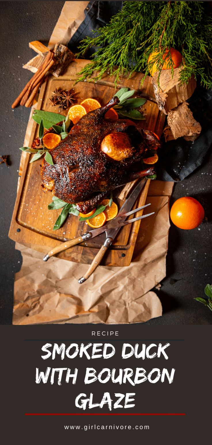 smoked duck with bourbon glaze on a cutting board next to oranges and herbs