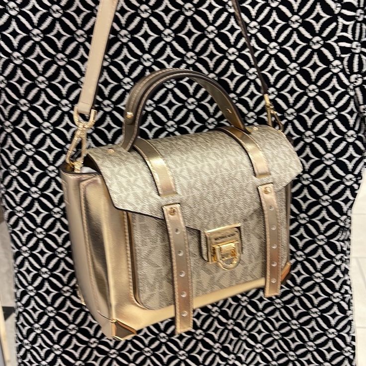 Michael Kors Manhattan Medium Top Handle School Satchel Crossbody Bag New With The Tag Authentic Color: Pale Gold Leather Pale Gold Color Signature Gold Color Hardware 9"W X 7.25"H X 4"D Adjustable Strap: 19"-21" Exterior Details: Front Slip Pocket Interior Details: 1 Zip Pocket And 1 Slip Pocket Lining: 100% Polyester Flip-Lock Fastening Dust Bag Not Included Michael Kors Manhattan 35f1gncs6v Pale Gold Md Th School Satchel Leather Ns Designer Gold Shoulder Bag With Adjustable Strap, Designer Gold Bag With Adjustable Strap, Designer Gold Satchel With Adjustable Strap, Gold Travel Satchel With Branded Hardware, Designer Gold Satchel With Detachable Strap, Designer Gold Bags With Branded Hardware, Shopping Satchel With Metal Hardware And Crossbody Shape, Gold Crossbody Shoulder Bag With Top Carry Handle, Gold Bags With Branded Hardware And Double Handle