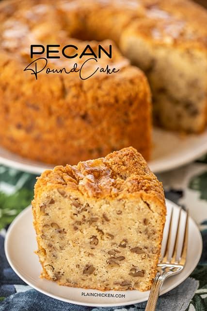 a piece of pecan pound cake on a white plate with a fork next to it