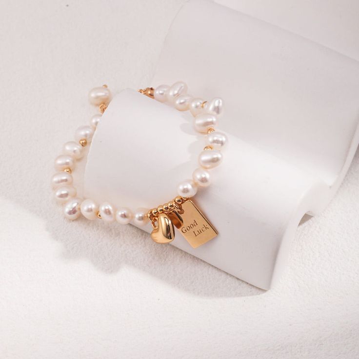 A stunning blend of timeless elegance and meaningful symbolism. This exquisite piece alternates between lustrous pearls and pure silver beads, creating a harmonious balance that speaks to both tradition and modernity. The good luck charm sets this bracelet apart and infuses the piece with positive energy and fortune. Great for either daily wear or for special occasions. Embrace the charm of good fortune today. Pearl Type: Freshwater Pearls Pearl Quality: [Shape]: Baroque [Size]: 7cm [Blemish]: M Dainty Pearl Bracelet With Pendant As Gift, Dainty Baroque Pearl Bracelet For Gift, Dainty Baroque Pearl Bracelet Gift, Elegant Bracelet With Baroque Pearl Charm, Delicate Pearl Pendant Bracelet As Gift, Gift Pearl Bracelet With Baroque Pearl Charm, Elegant Charm Bracelet With Pearl And Round Beads, Gift Baroque Pearl Bracelet With Pearl Charm, Baroque Pearl Bracelet With Pearl Charm As Gift