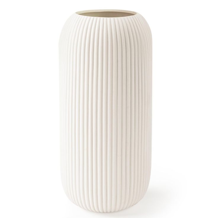 a white vase sitting on top of a table