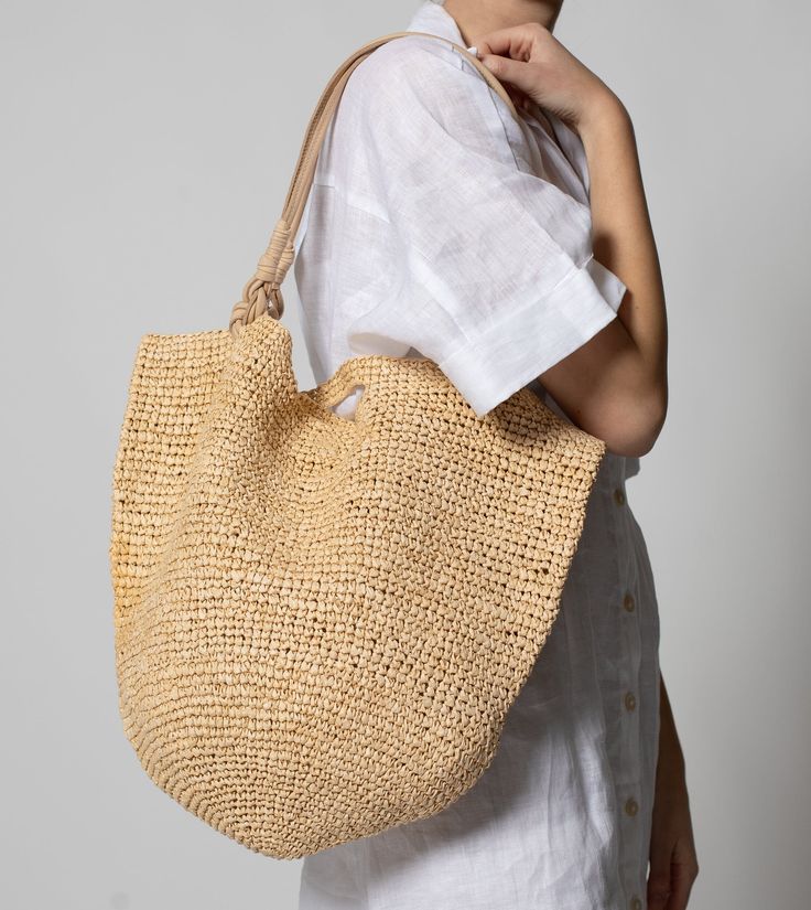 Ethically handmade in India, the Graciela Raffia Shoulder Bag is a staple piece to your everyday. This tote will not only hold your everyday essential items but will add as an accessory piece to your look. Ethically Handmade in India Made of paper raffia Handles made from cow leather Raffia tote bag with leather handles Interior zipper pocket Rafia Bag, Raffia Tote Bag, Zodiac Bracelet, Summer Tote Bags, City Outfits, Raffia Bag, Resort Collection, Essential Items, Black Handbags