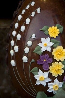 a decorative vase with flowers painted on it