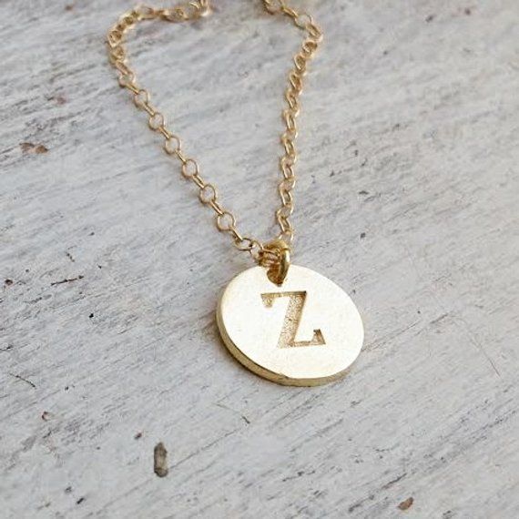 Custom Initial Necklace, hand stamped disc for your choice. Very delicate, simple and dainty necklace.A special gold initial disc connected to 14 K gold filled chain . Great idea gift for anniversary, Mother's Jewelry, best Friends, sister and co. Special holiday gift for someone you LOVE;) ****Please specify your letter in the "note to seller"  box before checkout***Necklace  Measures Approximately 17"Made from 14k gold filled or sterling silver.Initial disc Measures Approximately 0.4"If you wo Simple Gold Sterling Silver Initial Necklace, Simple Gold-colored Sterling Silver Initial Necklace, Simple Gold-toned Sterling Silver Initial Necklace, Gold Initial Necklace Hand Stamped For Gift, Gold Hand Stamped Initial Necklace Gift, Gold Hand Stamped Initial Necklace For Gift, Dainty Hand Stamped Initial Pendant Charm Necklaces, Gold Hand Stamped Round Disc Charm Necklace, Dainty Hand Stamped Initial Pendant Charm Necklace