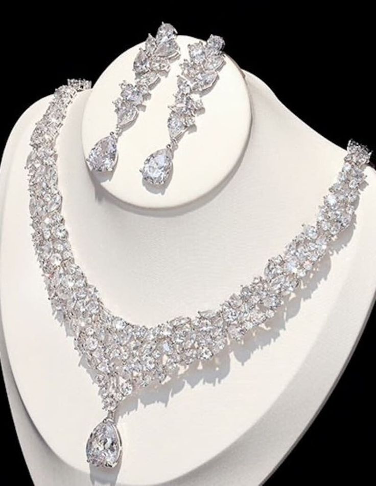 BELLA TIARA INTRODUCES OUR ROYAL JEWELRY COLLECTION BEST SELLER Every piece is made to perfection, we only use the finest CZ simulated diamond for that dazzling and dramatic look and always at a fraction of the price of any bridal boutique. Absolutely stunning!!! you could see why its our best selling necklace set.. Dramatic bold Swarovski crystal statement necklace set. for the unforgettable you, approx 16" long, along with 2 1/4" long drop drop pierced earrings. 14K white gold electroplated *N Wedding Necklace Set, Diamond Jewelry Set, Bridal Accessories Jewelry, Crystal Statement Necklace, Bridal Necklace Set, Diamond Necklace Set, Swarovski Crystal Necklace, Dope Jewelry, Hair Jewelry Wedding