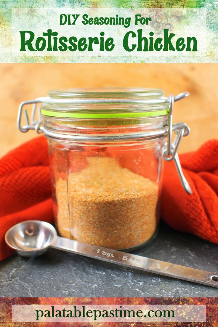 a glass jar filled with dirt sitting on top of a table next to a spoon