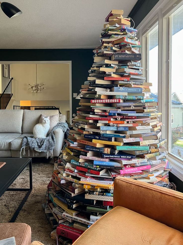 a christmas tree made out of books in a living room