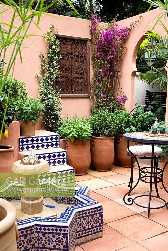 an outdoor patio with potted plants and tables