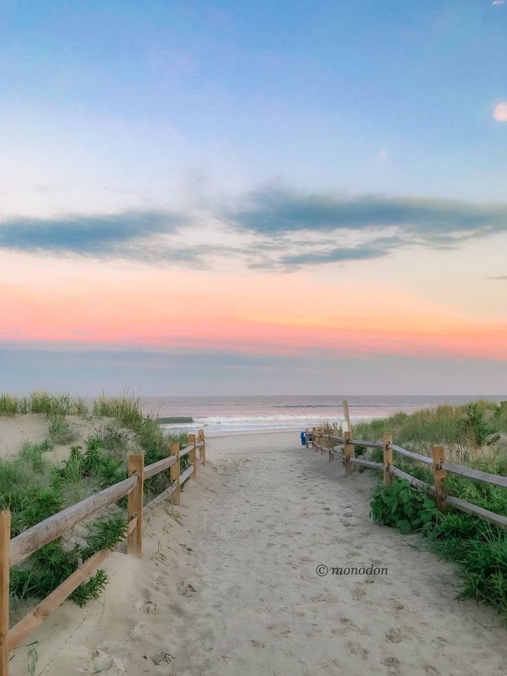 a path leading to the beach at sunset