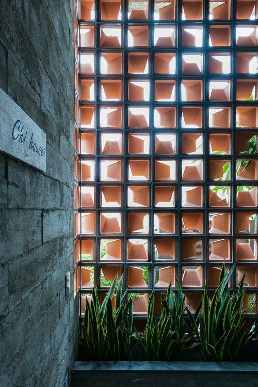 the entrance to an office building with plants growing out of it