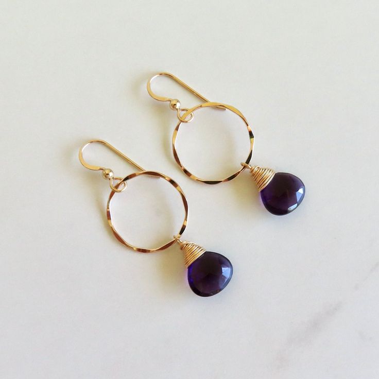 Amethyst Gemstone Earrings~ Pretty wire wrapped faceted purple amethyst gemstones dangles from 14k gold fill textured rings. *This listing is for the earrings in the first pictures, ready to ship* Hoops 1" Shop~ http://www.etsy.com/shop/HanaMauiCreations?ref=pr_shop_more International buyers please read our shipping policies before ordering~ POLICIES~ https://www.etsy.com/shop/HanaMauiCreations/policy?ref=shopinfo_policies_leftnav Teardrop Amethyst Jewelry With Faceted Detail, Faceted Teardrop Amethyst Jewelry, Teardrop Faceted Amethyst Jewelry, Wire Wrapped Amethyst Drop Earrings, Faceted Hoop Jewelry For Gifts, Purple Wire Wrapped Drop Earrings, Faceted Amethyst Drop Earrings, Faceted Amethyst Dangle Jewelry, Faceted Amethyst Round Jewelry