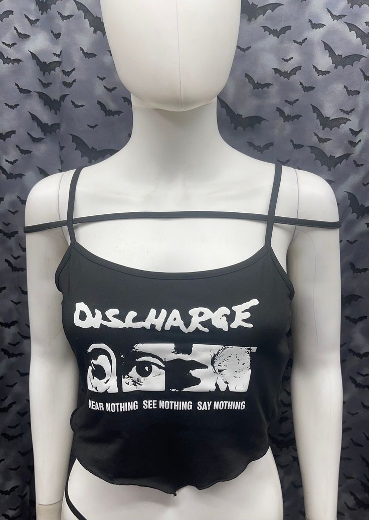 This is a black sleeveless strappy Discharge cropped tank top with a bandana style front. This has a Discharge image screen printed on the front. 91% polyester/ 9% elastane These are handmade screenprinted and slightly vary from the photo. Please feel free to email me any questions. Thanks for looking. The seller is not responsible for any lost or stolen packages. Edgy Cropped Top For Streetwear, Stretch Punk Crop Top For Streetwear, Black Casual Crop Top For Music Festival, Alternative Cropped Tops For Streetwear, Fitted Grunge Crop Top For Streetwear, Edgy Black Tank Top For Halloween, Casual Black Crop Top For Music Festival, Alternative Cropped Streetwear Tops, Stretch Grunge Graphic Print Crop Top