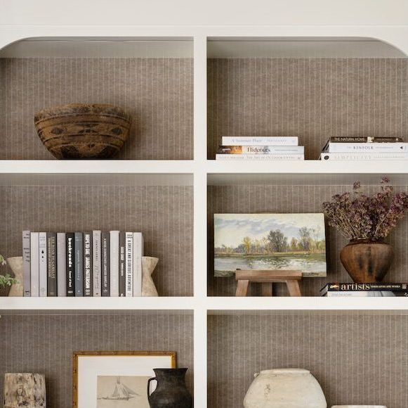 a book shelf filled with books and vases