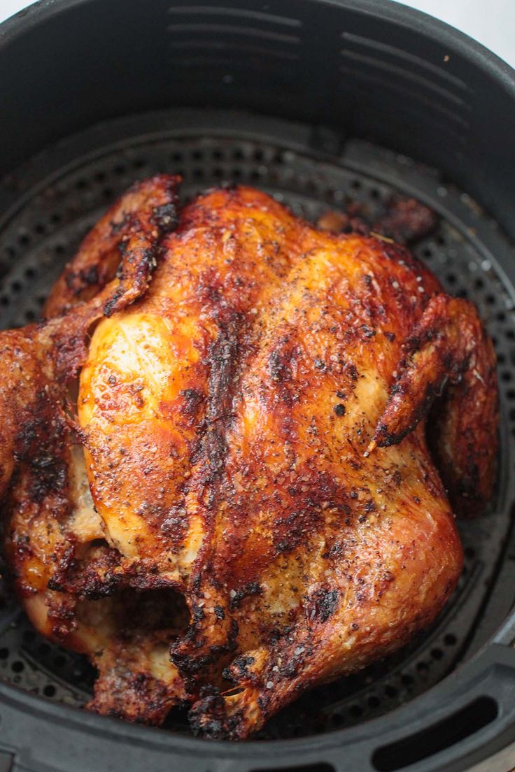 a close up of a chicken in an air fryer