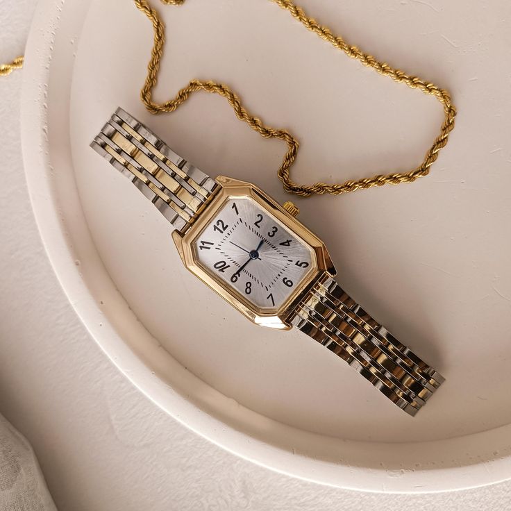 💎 Product Specifications: ➡ Case Diameter: 20mm x 30mm ➡ Material: Stainless stell ➡ Case Color: Gold ➡ Band Color: Silver and Gold ➡ Dial Shape: Rectangular  ➡ Strap Type: Metal Band ➡ Movement: Quartz ✈Free shipping ➡  Key Features: 💎 Stylish Two-Tone Design: The combination of gold and silver tones adds a touch of luxury and versatility, making it easy to pair with any outfit. 💎 Rectangular Dial: The unique rectangular dial with Roman numerals provides a classic look while ensuring easy re Timeless Rectangular Watch Accessories For Everyday, Timeless Rectangular Everyday Watch Accessories, Everyday Timeless Rectangular Watch Accessories, Rectangular Quartz Watch For Everyday Use, Classic Rectangular Watch Accessories For Everyday, Classic Everyday Rectangular Watch Accessories, Classic Square Watch Accessories For Gifts, Rectangular Quartz Watches For Everyday Use, Everyday Rectangular Watches With Metal Dial