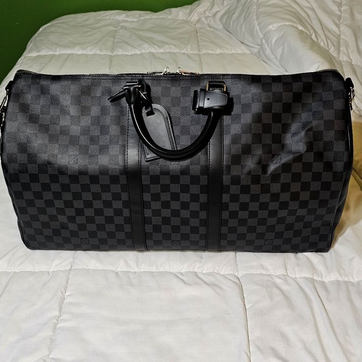 New In Perfect Condition!! Comes With Original Dust Bag And Orange Lv Retail Bag/Box This Urban Travel Bag In A Revisited Classic, Damier Graphite Canvas, Is Not Only Stylish But Also Resistant And Light. Hand Held With A Removable Shoulder Strap Makes It Extremely Practical To Use. 21.7 X 12.2 X 9.4 Inches (Length X Height X Width) - Coated Canvas - Natural Cowhide Leather Trimmings - Cotton Textile Lining - Silver Brass Pieces - Double Zip Closure - Removable Leather Id Holder - Padlock - Cabi High-end Black Bags For Business Trips, Designer Black Tote Duffle Bag, Designer Black Travel Bag, Luxury Black Shoulder Bag For Business Trips, Designer Black Travel Bag With Top Handle, Designer Black Rectangular Travel Bag, Designer Black Bags For Business Trips, Designer Black Duffle Bag With Leather Handles, Luxury Black Tote Travel Bag