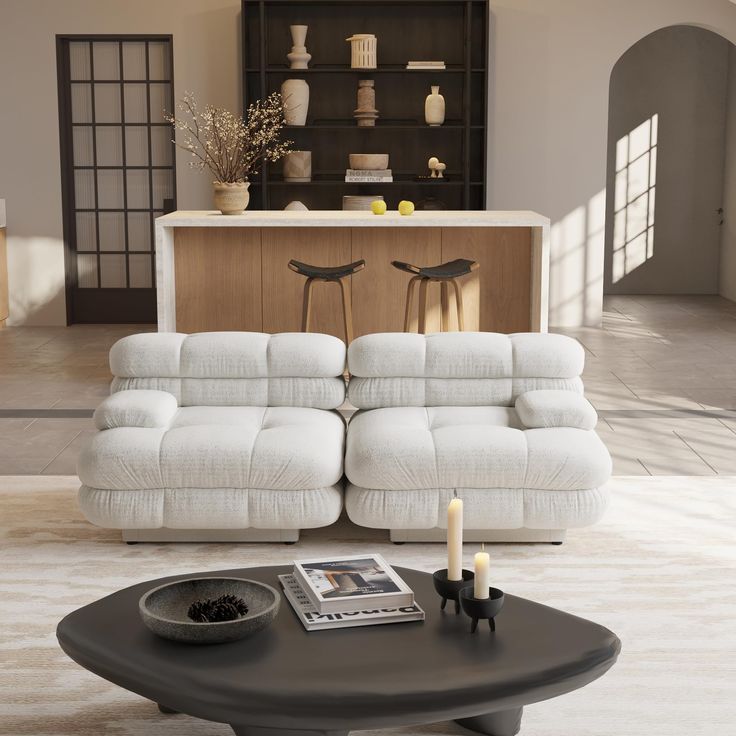 a living room with a white couch and coffee table