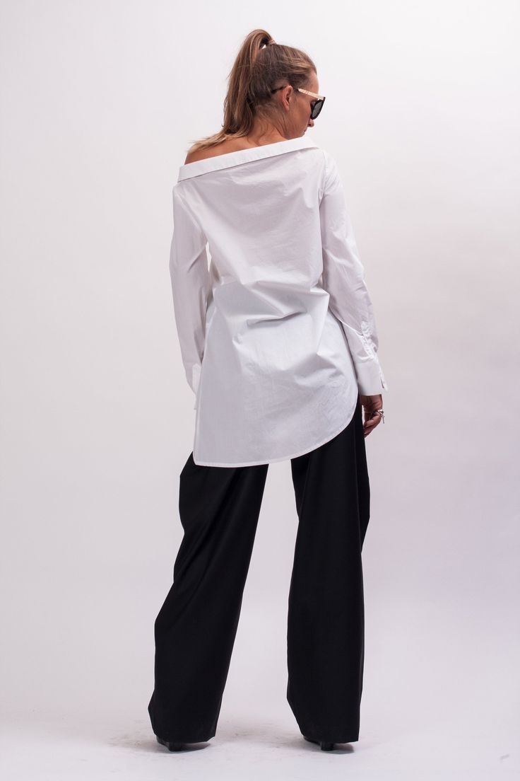 Easy and breezy, the Unstoppable Cotton womens white shirt features an asymmetrical construction, a wide avant garde collar, relaxed sleeves, and an asymmetrical button closure. With black pants, this white cotton long sleeve shirt makes Monday mornings bearable. The White asymmetrical shirt is designed to be comfortable and not troublesome to wear. After wearing this White long sleeve shirt women, you will love it even more. The white blouse for women is made of high quality fabric with cottone Oversized Asymmetrical Cotton Shirt, Oversized Asymmetrical Cotton Blouse, Modern Oversized White Blouse, Oversized Cotton Blouse With Asymmetrical Hem, Chic Cotton Shirt With Asymmetrical Hem, Oversized Blouse With Asymmetrical Hem For Spring, White Asymmetrical Cotton Shirt, Curved Hem Tops For Daywear In Spring, Versatile Long Sleeve Office Shirt