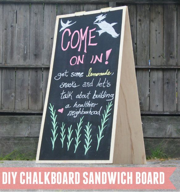 a chalkboard sign sitting in front of a wooden fence with the words come on it