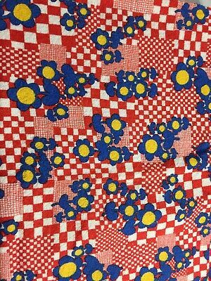 a red and white checkered table cloth with blue flowers on the center, yellow dots in the middle