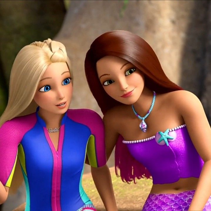 two barbie dolls sitting next to each other in front of some trees and rocks, one is wearing a purple swimsuit