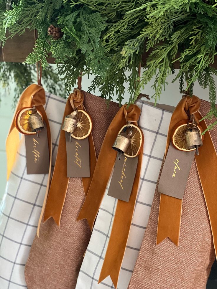 christmas stockings with ribbons hanging from them