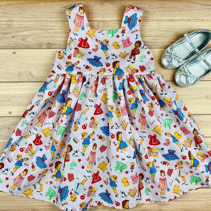 "Visit https://www.etsy.com/shop/ateliergaiana/?section_id=37844480 to check out other summer dresses from AtelierGaiana! Your search for the perfect girls summer dress, a chic and fun dress with a retro vibe or a vintage vibe, picnic dress, garden dress or garden baby outfit, a garden baby shower gift, a beautiful tea party dress or a gorgeous pink twirl sundress is over! Please meet Retro Paper Dolls \"Tina\" dress by AtelierGaiana! This girls dress, toddler dress, or baby dress with a full ga Cute A-line Sundress For Garden Party, Pink Sundress For Summer Playdate, Summer Vintage Dress With Ruffles For Dress-up, Retro Spring Playtime Dresses, Vintage Sleeveless Dress For Tea Party, Pink A-line Sundress For Garden Party, Sleeveless Cotton Dress For Tea Party, Summer Sleeveless Pinafore Dress For Playtime, Cute Summer Pinafore Dress For Playdate