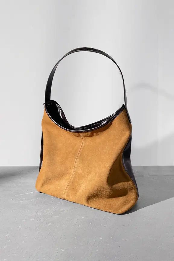 Chic Leather Accessory: Elevate Every Ensemble Step into a world of refined minimalism with our designer hobo shoulder bag. Showcasing a unique saddle shape and precision-crafted from color-blocked suede leather, this piece marries opulence with a relaxed European flair. Available in shades of caramel brown and rich cocoa, accentuated by contemporary contrast detailing, it stands as an ode to impeccable craftsmanship. Inside, you'll find a thoughtfully partitioned design, bolstered by a robust p Elegant Everyday Suede Hobo Bag, Camel Leather Shoulder Bag For Work, Camel Leather Bag For Work, Modern Camel Leather Shoulder Bag, Brown Smooth Grain Hobo Bag For Work, Chic Suede Shoulder Bag For Work, Chic Saddle Shoulder Bag For Everyday Use, Chic Everyday Saddle Shoulder Bag, Chic Rectangular Hobo Bag With Leather Backing