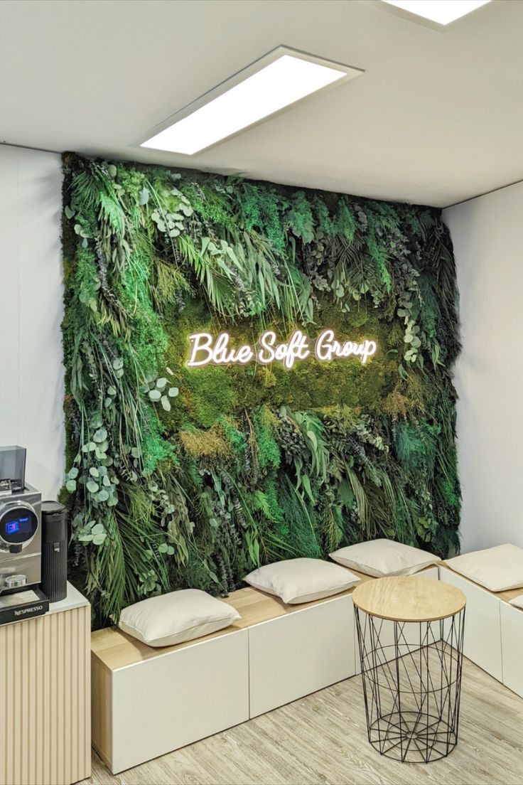 an office with a green wall and coffee machine