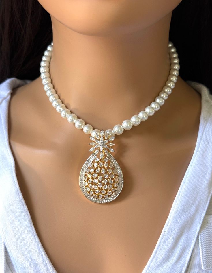 Discover the Elegance of Handcrafted Luxury with Our CZ American Diamond Pearl Mala Necklace This stunning necklace boasts a harmonious blend of high-quality Cubic Zirconia (CZ) stones, known for their dazzling brilliance and diamond-like radiance, and lustrous pearls that evoke a sense of timeless sophistication. Elegant Bridal Necklace With Detachable Pendant, Elegant Bridal Necklace With Detachable Pendant For Wedding, Wedding Necklace With Detachable Cubic Zirconia Pendant, White Gold Necklaces With Detachable Pendant For Weddings, White Gold Necklace With Detachable Pendant For Wedding, Wedding Jewelry With Pearl And Diamond Accents, Formal Diamond White Necklace With Detachable Pendant, Elegant Wedding Jewelry Sets With Detachable Pendant, Silver Necklace With Detachable Pendant For Wedding