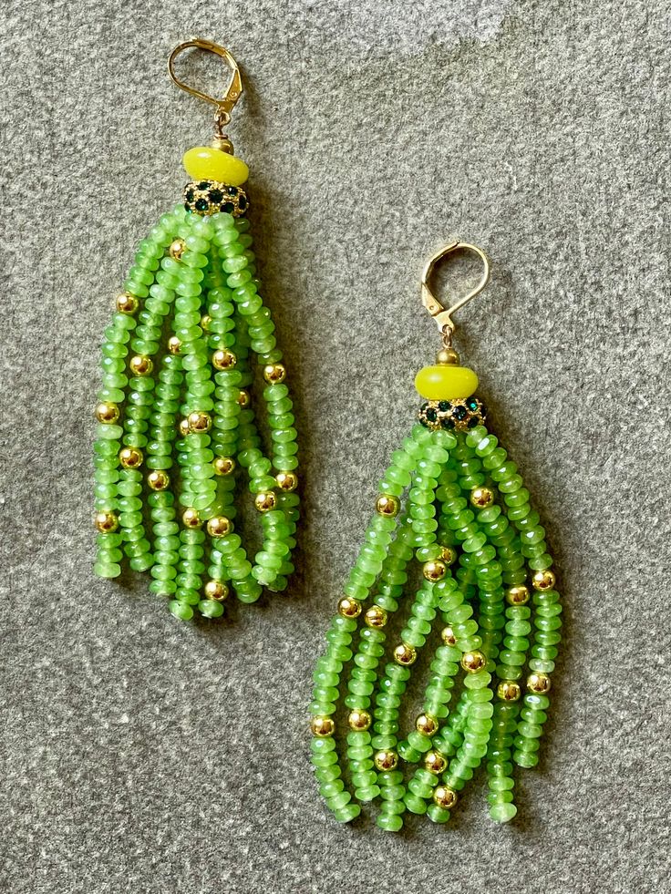 Meredith Waterstraat combines vintage and modern beads, gemstones, metals and other found and natural materials to create remarkable one-of-a-kind designs. We love her unique aesthetic and utterly original sensibility. "Green Tassel" earrings of faceted green jade beads on vermeil ear hooks, 3" long. Unique Dangle Earrings With Gemstone Beads, Artisan Dangle Earrings With Faceted Beads, Artisan Hand-strung Earrings For Gift, Artisan Hand-strung Dangle Earrings, Green Spiritual Jewelry With Dangling Beads, Spiritual Green Jewelry With Dangling Beads, Elegant Green Gemstone Beaded Earrings, Spiritual Green Beaded Earrings, Green Beaded Dangle Earrings With Natural Stones