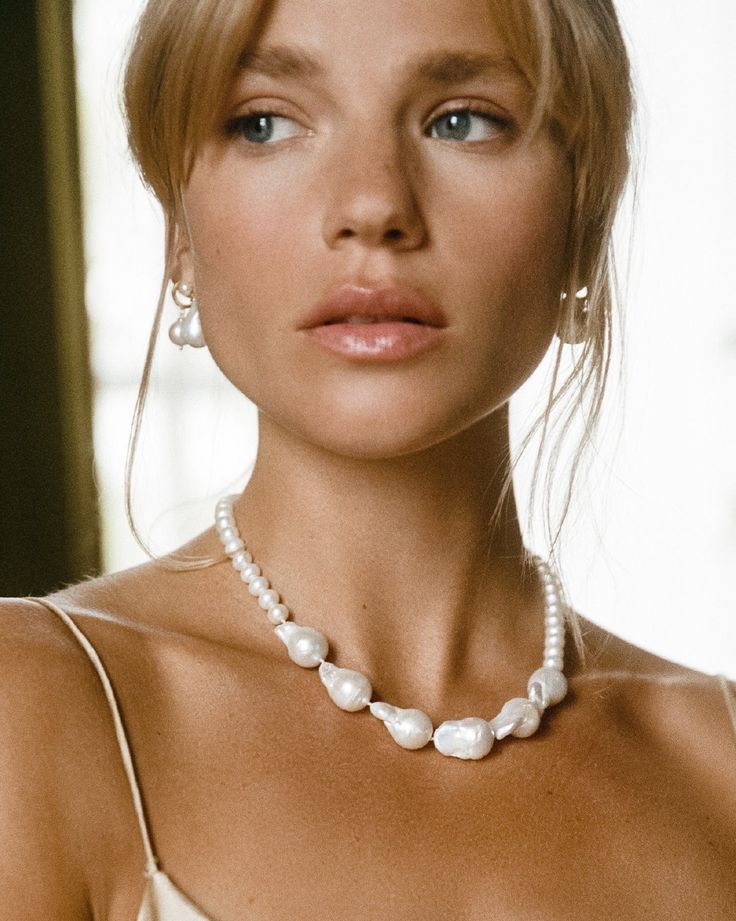 Perfection is boring, we prefer something more unique - just like you & this pearly little number. The Champagne Necklace combines smaller Keshi pearls with the organic forms of bold baroque pearls, to create an elegant yet modern piece of art.

Take centre stage & wear the Champagne Necklace as a standalone statement or pair with our teardrop-shaped Pamplona Earrings for a look as bold as your beautiful heart. 
Details

Handcrafted in a thick layer of 18k gold on sterling silverChain length: 42 Elegant Baroque Pearl Beaded Necklaces With Round Beads, Elegant Baroque Pearl Beaded Necklaces, Wedding Beaded Necklaces With Baroque Pearl Drop, Wedding Baroque Pearl Beaded Necklaces With Pearl Drop, Wedding Baroque Pearl Beaded Necklace With Pearl Drop, Wedding Baroque Pearl Beaded Necklace With Pendant, Wedding Akoya Pearl Beaded Necklaces With Round Beads, Elegant Pearl Necklace With Polished Beads For Wedding, Elegant Baroque Pearl Beaded Necklace For Wedding