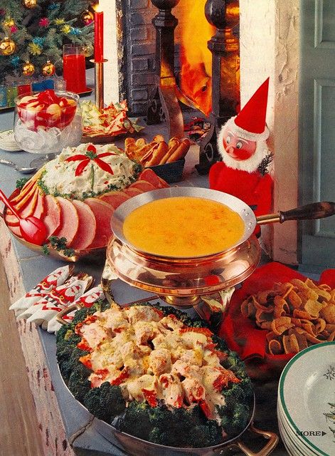 an assortment of food on a table with santa's helper in the background