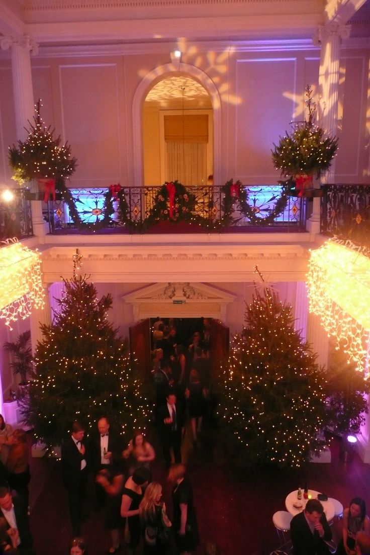 an overhead view of people standing in a room with christmas decorations on the walls and trees