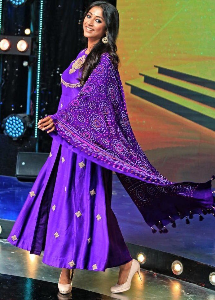 Features a purple kurta embellished with dori and resham peacock motifs. Teamed with matching pants and a georgette bandhani dupatta. Composition : Kurta and Pants- Moonga silk, Dupatta -Georgette dupatta Care: Dry Clean Only and Vacuum Storage This product can be customised for sleeves, length of blouse and neckline Delivery : 4-6 weeks as the product is hand crafted. For more information and sizes please contact fabiliciousfashion@gmail.com or visit our Copenhagen studio.About the Designer : Pink City by Sarika, established in 2014, is a young and modern brand that offers modern indo western silhouettes with old world sophistication. With a meticulous eye for detail and an unwavering passion for creating beautifully made clothes, Pink City by Sarika has become synonymous with Indian indo Bollywood Style Bandhani Print Floor-length Kurta, Purple Palazzo Set With Dabka Work And Straight Kurta, Purple Bollywood Palazzo Set With Dupatta, Bollywood Purple Palazzo Set For Diwali, Bollywood Style Purple Palazzo Set With Dupatta, Bollywood Style Designer Bandhani Print Salwar Kameez, Unstitched Purple Palazzo Set For Navratri, Purple Palazzo Set With Zari Work For Navratri, Bollywood Style Purple Palazzo Set With Straight Kurta