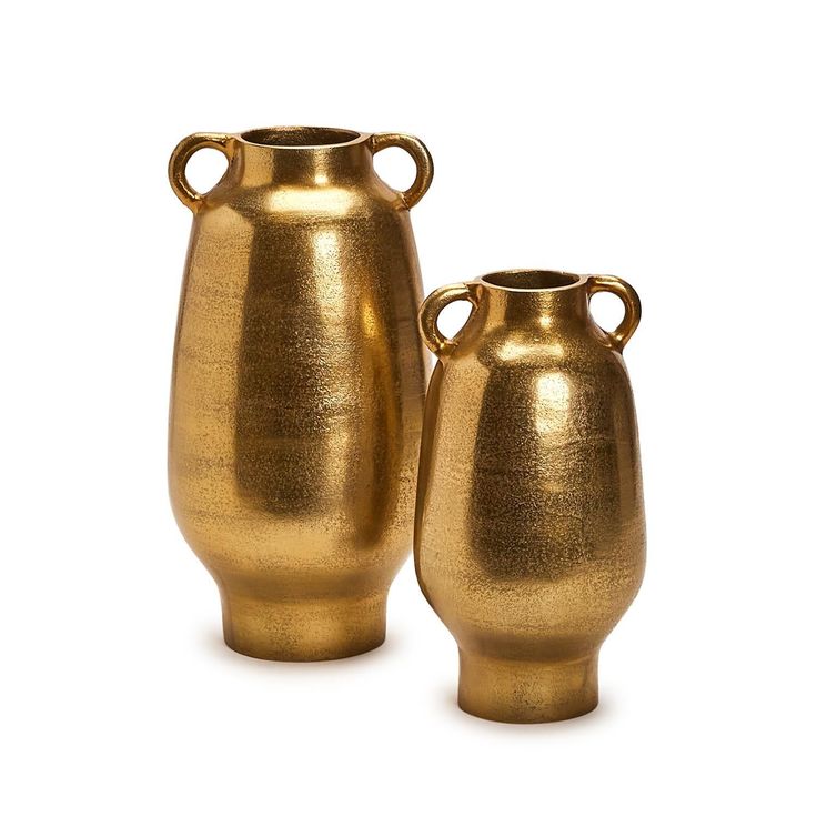 two gold vases sitting next to each other