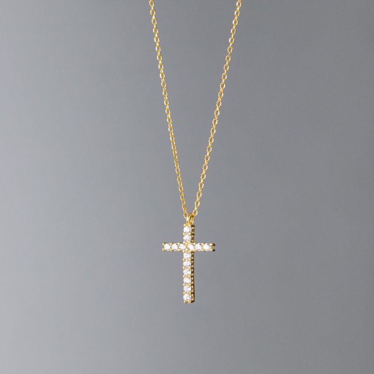 The Cross: Radiant Glow The Cross Pendant Necklace embodies classic simplicity, offering a timeless elegance that enhances any outfit. Its sparkling simulated diamond center adds a touch of luxury, creating a refined yet understated look that’s perfect for both casual and formal occasions. Crafted from sterling silver and layered with platinum, this pendant combines durability with a lasting shine. The minimalist cross design brings a subtle sophistication, making it an ideal choice for everyday Small Cross Necklace Gold, Gold Cross Jewelry, Wishlist Collage, Gold Necklace Cross, Cross Necklace Gold, Cross Choker Necklace, Schmuck Gold, Gold Schmuck, Jewelry Cross