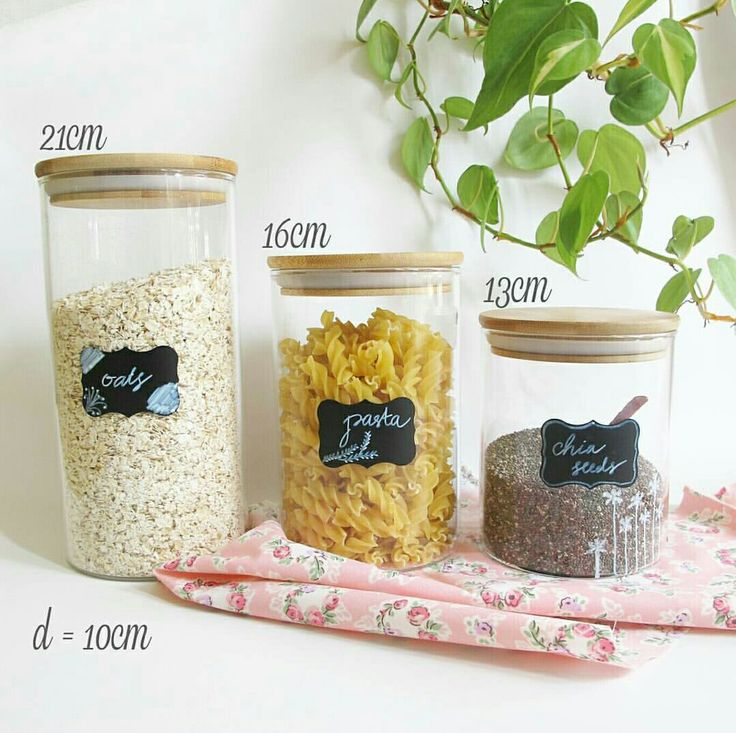 three jars filled with different types of pasta and seasoning on top of a table