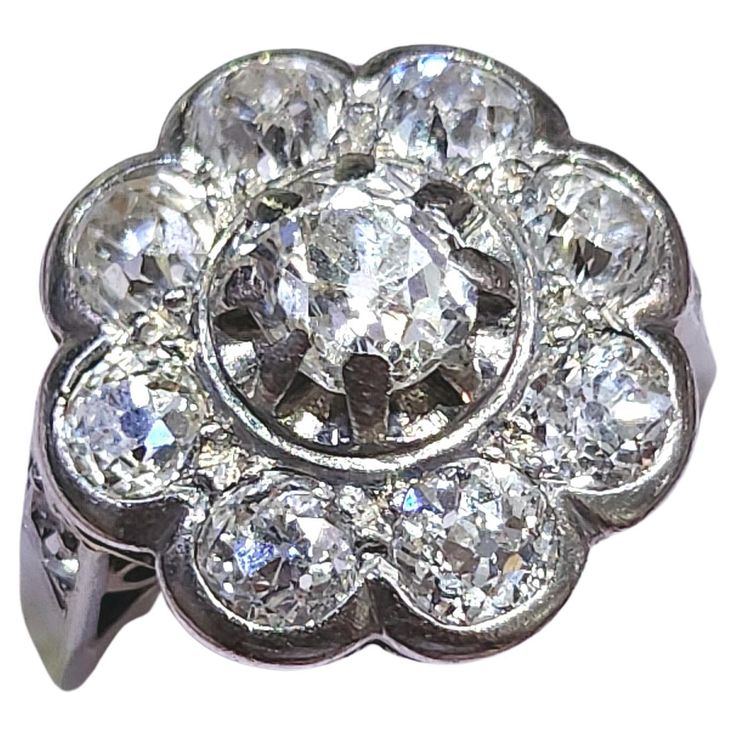 an antique diamond cluster ring in white gold