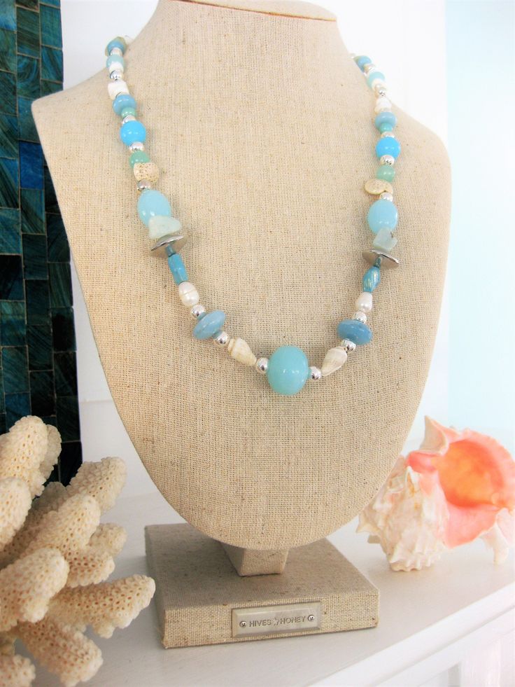 Natural stone beaded necklace with blue stone beads. This is a one of a kind necklace the only one made. Click to see it. This beautiful beach style necklace is made with light sea foam blue beads, shells, shell pieces, freshwater pearls, and silver metal beads. This necklace is one of a kind, and makes a great gift for women. The necklace has a lobster clasp, and is a short necklace at 22 inches long, but can be made shorter, or longer with a chain extension, on request. This necklace is ready Ocean-inspired Turquoise Beaded Necklace, Turquoise Ocean-inspired Beaded Necklace, Turquoise Beaded Necklaces With Natural Stones For Beach, Natural Stone Strand Beaded Necklace For Beach, Blue Turquoise Necklace With Polished Beads For Beach, Beach Strand Necklaces With Natural Stones, Beach Turquoise Necklace With Polished Beads, Turquoise Ocean-inspired Necklace With Natural Stones, Ocean-inspired Turquoise Necklace With Natural Stones