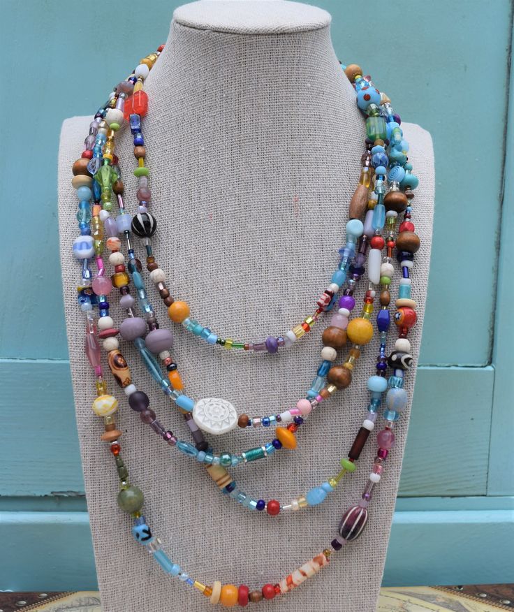 "This showstopping jewelry set is handmade from a variety of high-quality glass beads, including millefiori beads. The necklace has five strands in a true rainbow of colors and parade of shapes and sizes. Includes a matching bracelet and earrings. The bracelet is currently 7.5\", but I would be happy to customize for you." Cheap Multicolor Strand Jewelry, Colorful Adjustable Multi-strand Jewelry, Multi-strand Czech Glass Jewelry With Large Beads, Artisan Multi-strand Multicolor Beaded Bracelets, Czech Glass Large Beads Multi-strand Jewelry, Artisan Multicolor Multi-strand Beads, Handmade Multi-strand Glass Jewelry, Multicolor Czech Glass Gemstone Beads, Bohemian Rainbow Glass Jewelry