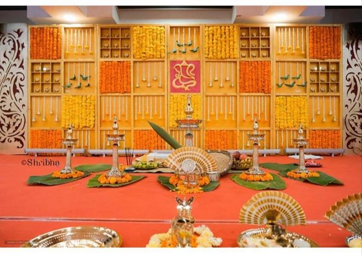 an elaborately decorated banquet hall with orange and gold decorations