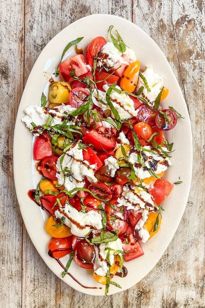 a white plate filled with lots of different types of food on top of a wooden table