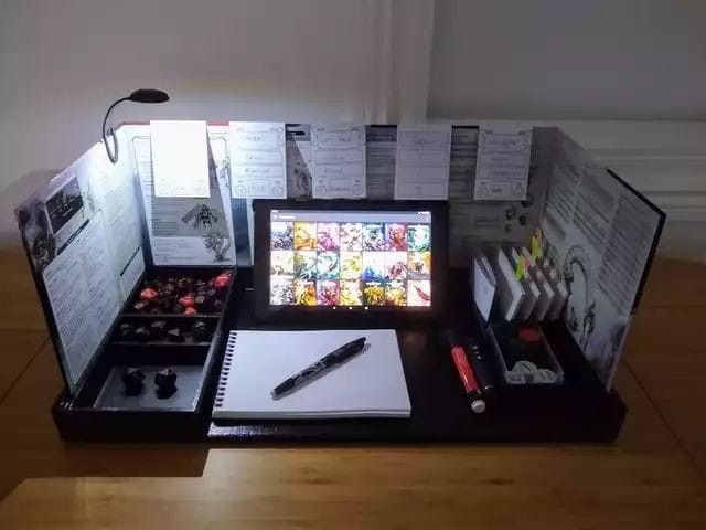 a desk with many items on it including pens and notebooks