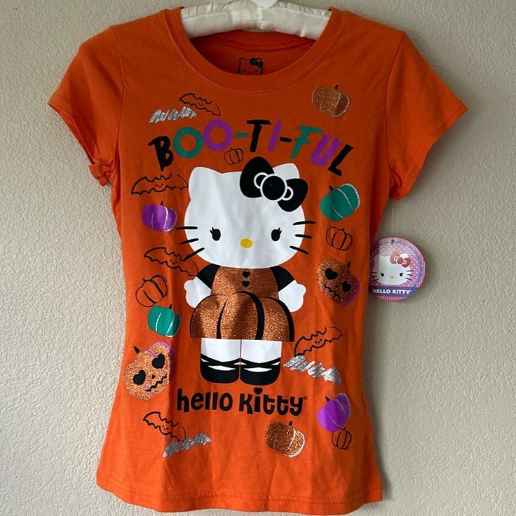 What A Cute Halloween Tee!! New With Tags! - Pit To Pit Approximately 15” - Top Of Shoulder To Bottom Approximately 21.5 Cute Orange Tops With Cartoon Print, Cute Multicolor Fall T-shirt, Cute Orange Tops For Halloween, Cute Orange Top For Halloween, Orange Tees, Hello Kitty Halloween, Halloween Tees, Cute Halloween, Kids Shirts