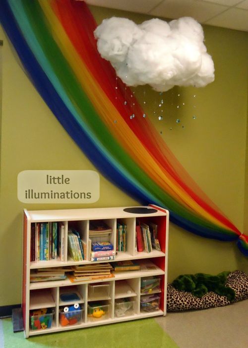 a rainbow wall hanging over a book shelf