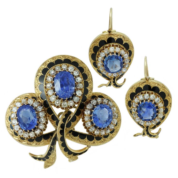 This magnificent Victorian jewelry suite consists of a pendant-brooch and a pair of earrings featuring an intricate filigree design hand-crafted in 18k yellow gold and contrasted with black enamel. This suite is beautifully prong-set with natural unheated faceted blue oval sapphires - an estimated 19 carats in the brooch and 5 carats in the earrings and accented with sparkling mine-cut diamonds - an estimated 4 carats in the brooch and 2 carats in the earrings. Made in France circa 1900s. Measur Vintage Modern Jewelry, Pendant Brooch, Antique Brooches, Gold Diamond Necklace, 18k Gold Jewelry, Filigree Design, Victorian Jewelry, Diamond Gold, I Love Jewelry