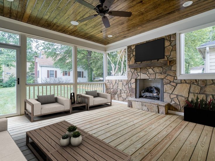 a living room filled with furniture and a flat screen tv on top of a wooden floor