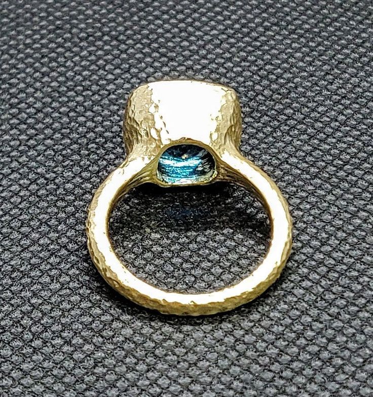 14K solid yellow gold hammered ring with 0.15 ct. SI1, G color natural brilliant diamonds & 7.80 ct. 11x11 mm cushion shape AAA natural London blue topaz. This item can also be ordered in rose or white gold with different color gemstones such as citrine, amethyst, green amethyst, pink amethyst, smoky quartz, white topaz, garnet, peridot, morganite & aquamarine, please contact me for a quote as each gemstone varies in price. I am a manufacturer of fine jewelry for over thirty years, custo Gold Topaz Ring With Single Cut Diamonds, Gold Jewelry With Rose Cut Diamonds And Blue Topaz, Yellow Gold Hammered Diamond Rings, Hammered Yellow Gold Diamond Rings, Unique Gold Sapphire Ring With Diamonds, Fine Jewelry Gold Diamond Ring With Blue Topaz, Unique Gold Ring With Blue Topaz, Gold Topaz Ring With Single Cut Diamonds For Anniversary, Gold Topaz Ring With Single Cut Diamonds For Gift