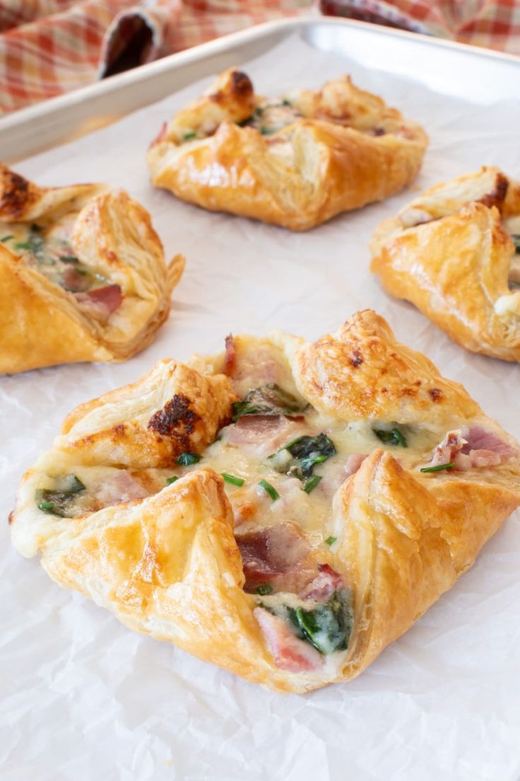 several small pastries are on a white tray